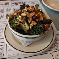 Broccoli and nuts side dish, has a dip along the sides of the bowl at Superiority Burger in New York City