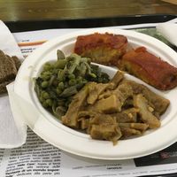 3 dishes plate served with bread for €5.30. Seitan, a pea salad, and eggplant and cous could parcels at Sapore Vegano in Turin
