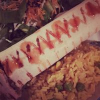 vegan burrito with sides of salad and rice. Stuffed with avocado and beans. at Appaloosa in Mykonos