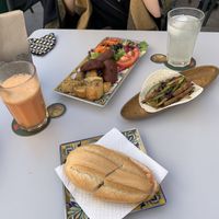 Vegan taco, vegan chorizo and bread roll with tomato at Recyclo Bike Cafe in Malaga