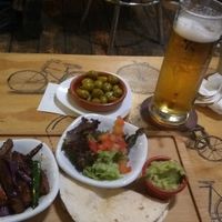 large beer and vegan taco at Recyclo Bike Cafe in Malaga