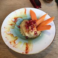 hummus with carrot sticks and pomegranate at Recyclo Bike Cafe in Malaga
