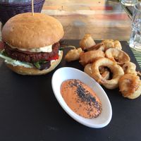 Special burger (quinoa based) with coleslaw filling and onion rings  at Cavoli Nostri in Naples
