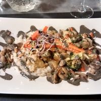 Seasonal vegetable Makloubeh and shiro-miso coco Acquerello risotto, mushrooms, black sesame sauce and sprouted seeds at La Table des Roy in Nantes