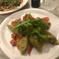 Mezzelune (ravioli) de espinacas con berenjena, tomatitos asados y rúcola fresca at Botanica Lab in Bologna