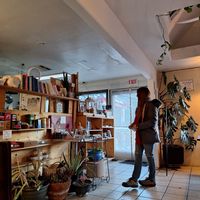 Me contemplating what book to check out. I recommend the Psychic Soul. at The Red Dot Vegetarian Kitchen in Frazier Park