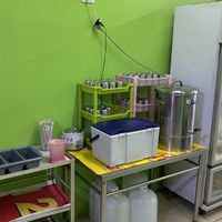 Silverware, drinking water, and ice in the cooler in the back.  at Jiya Chai in Phuket