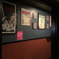 View of the bathroom hall. The decor is mostly black walls with tons of very punk posters.  at Black Water Bar in Portland