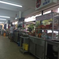 the helpful waitress plating up our food at Blue Boy Vegetarian Food Centre in Kuala Lumpur