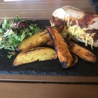 Vegan “meatball” sub. Homemade wedges and side salad. Amazing!  at The Green HeART Cafe  in Newquay