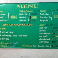 Menu posted on the wall by the entrance at Tu Hao in Hanoi