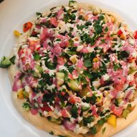 aubergine cubes on a hummus base with beetroot and tahini dressing.  at Aubergine in Bucharest