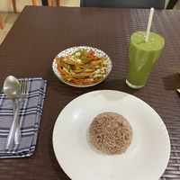 Fried veggies with rice and green smoothie   at Wellnessland Vegetarian Cafe in Cebu
