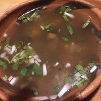Excelente caldito de champiñones con cilantro, cebollita y limón   at El Arbol Taqueria Vegetariana in Puebla