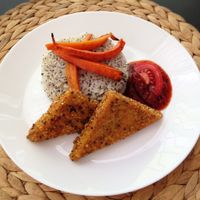 Burmese fried chickpea slices with tomato chutney, jasmine rice and roasted carrots at RepaRetek in Budapest