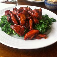Vegan bbq ribs on top of bed of kale  at Shangri-La Vegetarian in Brooklyn