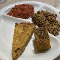 Vegan meatballs, lentil curry, vegan quiche, and vegetable farinata  at Flora in Verona