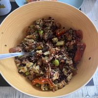 Bowl con riso venere e rosso, tofu all’aglio, edamame, verdure miste e semi.   at Feliz Cafe in Peschiera Del Garda