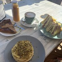 Pistachio pancakes, cheese and ham toastie, vegan cake   at Feliz Cafe in Peschiera Del Garda