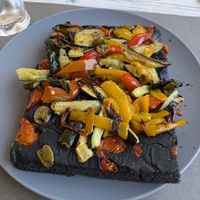 Focaccia with olives, tomatoes and Mediterranean veg at Feliz Cafe in Peschiera Del Garda
