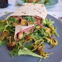 Piadina con zucchine saltate in padella, rucola, salame veg e formaggio veg at Feliz Cafe in Peschiera Del Garda