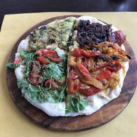 Delicious vegan pizza with vegan cheese and assorted vegetables  at Feliz Cafe in Peschiera Del Garda