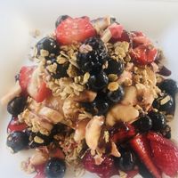 Breakfast pancakes with muesli and fresh fruit  at Feliz Cafe in Peschiera Del Garda