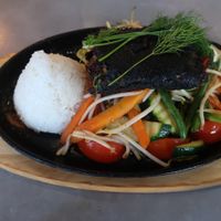Faux fish with vegetables and rice on a hot platter. at Quy Nguyen - Vegan Living in Berlin