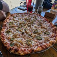 Large - vegan cheese, jalapeno, garlic, and caramelized onions at Red Tractor Pizza in Bozeman