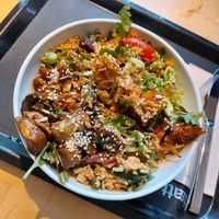 Bowl with multiple salads (beans, lentils, pasta, couscous), rice, mushrooms, jackfruit, tofu, soy meat, dressing, sesame & sunflower seeds, spring onion & fried onions at Sattgrün in Essen