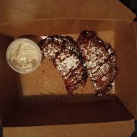 Bananas Foster empanadas with powdered sugar and icing on the side--ordered to go! at Bar Bombon in Philadelphia