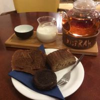 Roibosh tea with fresh coconut milk and a white poppyseed strudel, ginger biscuit and choc Oreo all raw style. at bistRAW & Tea in Prague