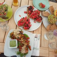 Avocado quinoa salad, filled sweet potatoes with tofu and veggies, hummus, guacamole, veggie balls, bruschetta, bread, juices, and beer. All delicious! at BIOFresh in Timisoara