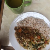 Tea and main plate with mixed veggies, "meaty" celery, and barley rice.  at Comedor Vegetariano in Huaraz