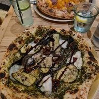 Pesto pizza in the front and tuna pizza in the back at Purezza in Brighton
