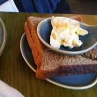 Side of toast and vegan butter with big breakfast  at Vegan Hippo in London