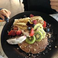 buckwheat pancakes - topped with coconut yoghurt, fresh seasonal fruit, caramelised pecans and maple syrup
 at Redemption - Chepstow in West London