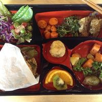 Bento Box.  Natto burger hiding under paper wrapping. at Tama Organic Life in Vancouver