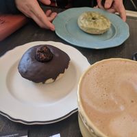 Chocolate truffle donut, matcha donut and an oat milk latte at Fat Cats in Austin