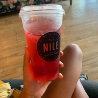 Straw kiwi tea with blueberry flavor so yum but syrup sits at the bottom so had to cover drinking hole to mix at The Nile in Mesa