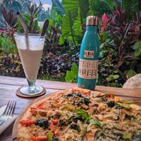 Vegan pizza, raspberry coconut mylkshake and the view! at Atman Kafe in Ubud