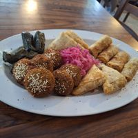 Falafel, vine leaf rolls, potato samosa and fried cabbage rolls at Mr Falafel in Maribor
