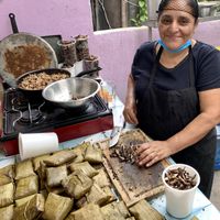 Woman making tamales in the back courtyard  at Suculenta in Tulum