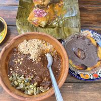 Tamale, mole and beans with plantain  at Suculenta in Tulum
