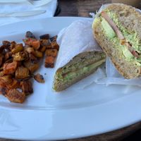 Veggie sandwich with Tofu Dill sauce, avocado, sprouts, tomato. Side of sweet potatoes   at Green Zebra Cafe in Sarasota