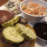 Jackfruit burger with vegan sides   at Aroma Thyme Bistro in Ellenville