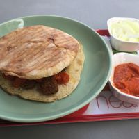 Ćevapi in flat bread with onion , the traditional side dish for Ćevapi. at Vege Fino Za Sve in Zagreb