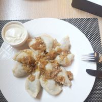 Dumplings with a filling of spinach, dried tomatoes and tofu, onion topping at Pierogarnia Mandu Oliwa in Gdansk