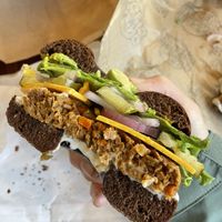 Pumpernickel rye with avocado, veggie patty, cheddar, avocado, red onion, cream cheese, mustard, pickles, lecture  at Blazing Bagels in Bellevue