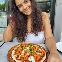 posing with my pizza at Cafe Gratitude in San Diego